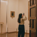 free-photo-of-a-woman-taking-a-photo-in-an-art-gallery