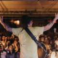 free-photo-of-back-view-of-a-musician-on-a-stage-with-arms-raised-towards-the-audience