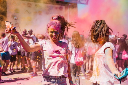 two-young-women-playing-enjoying-with-holi-col