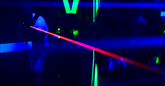 man-pointing-red-laser-beam-inside-laser-tag-arena-1