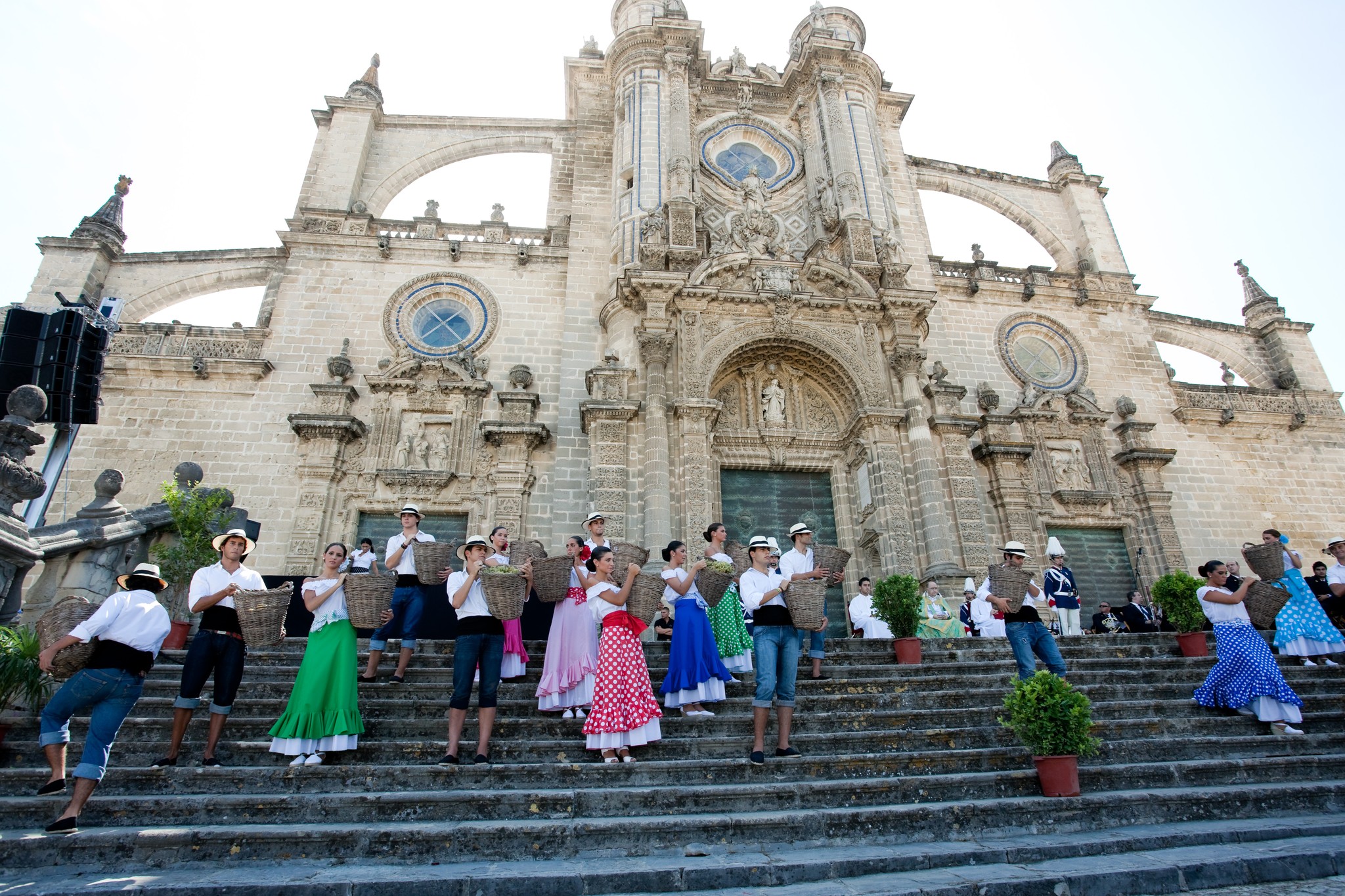 A wide angle shot of people on the stairs in front of an hold building 